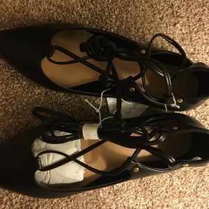 Black pointed toe tie up flats